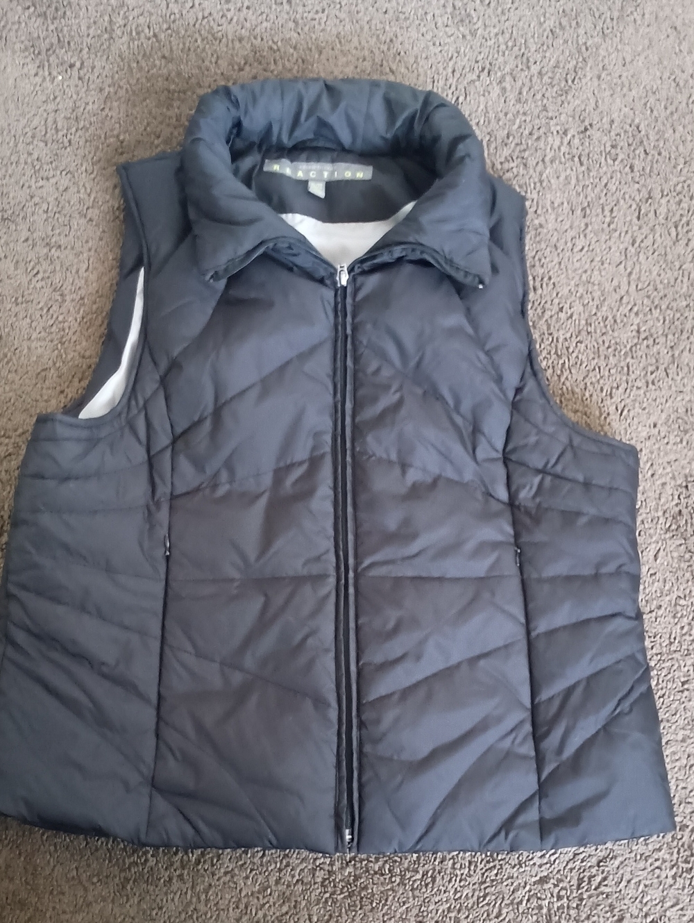 Kenneth Cole Reaction women's black puffer vest featuring a mock neck collar